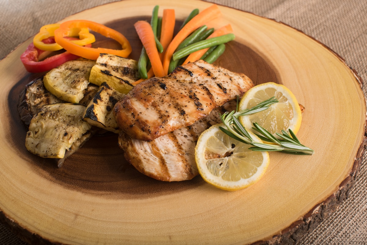 Grilled salmon with vegetables and quinoa representing a high-protein balanced meal