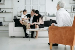 A financial advisor consulting with a young family about wealth transfer strategies.