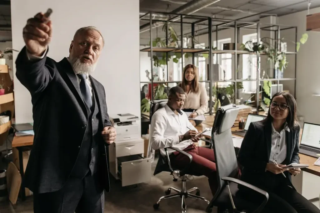 A professionally dressed man walking with crutches in a modern business environment, visually representing the need for key person disability insurance.